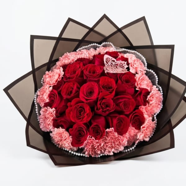 Red roses and pink carnations in a wrapped bouquet