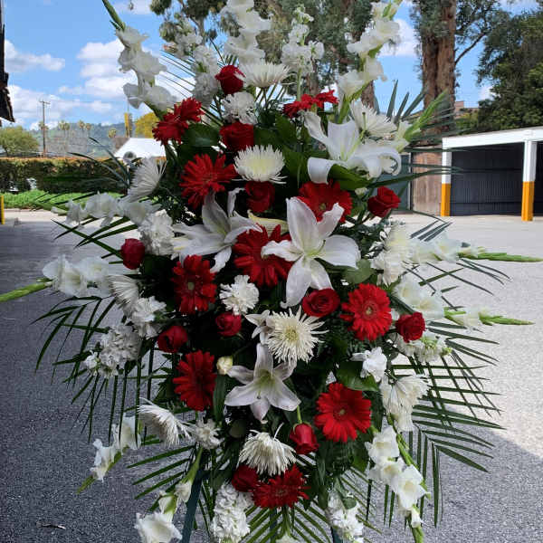 Tall standing floral spray with red and white flowers