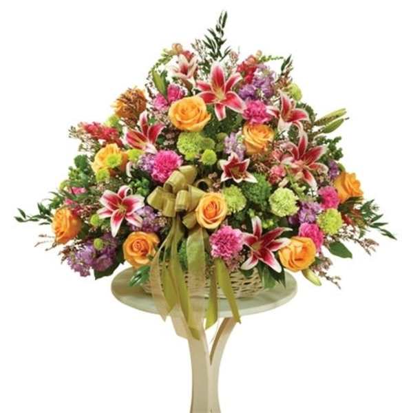 Large mixed bouquet with orange roses and red lilies on a stand