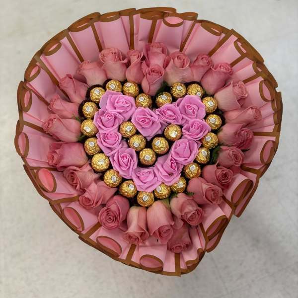 Chocolate heart and artificial flowers