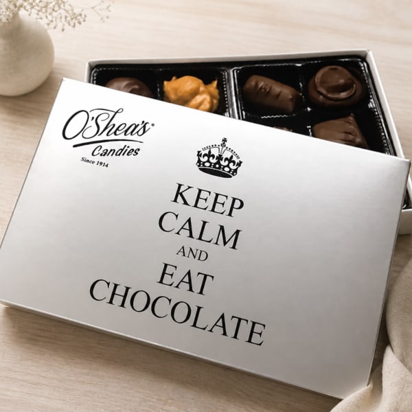 Box of assorted chocolates with a lid reading "Keep Calm and Eat Chocolate"