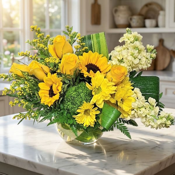 Yellow roses and sunflowers in a glass vase with white flowers