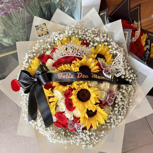 Bouquet of red roses and sunflowers with a black ribbon and tiara