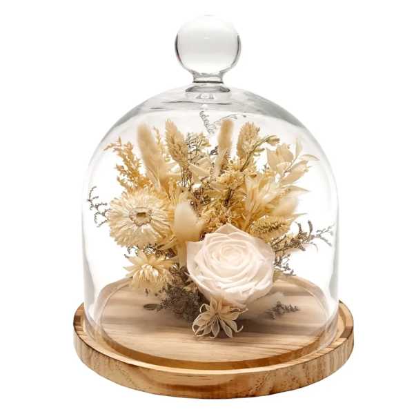 Dried floral arrangement under a glass dome on a wooden base