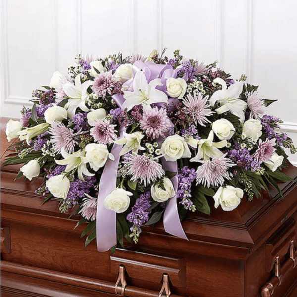 Lavender and white floral casket spray with lilies and roses