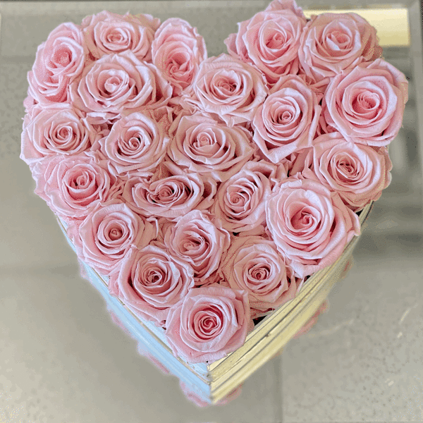 Heart-shaped box filled with pale pink roses