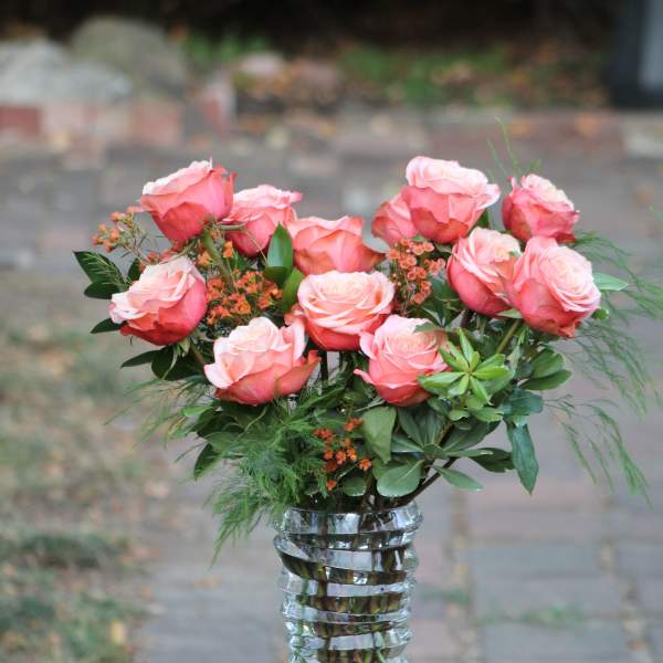 Pink roses arranged in a clear glass vase