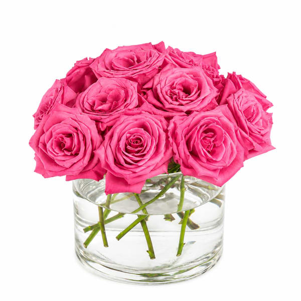Pink roses arranged in a clear glass vase