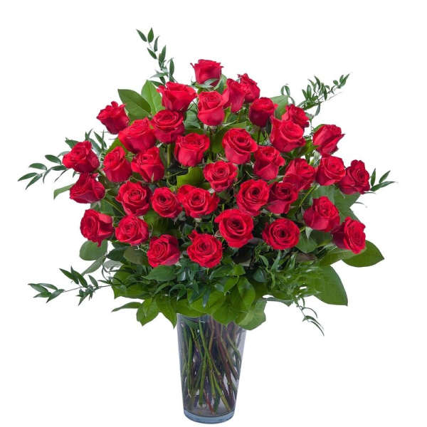 Red roses arranged in a clear glass vase