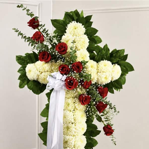 Cross-shaped floral spray with red roses and white chrysanthemums