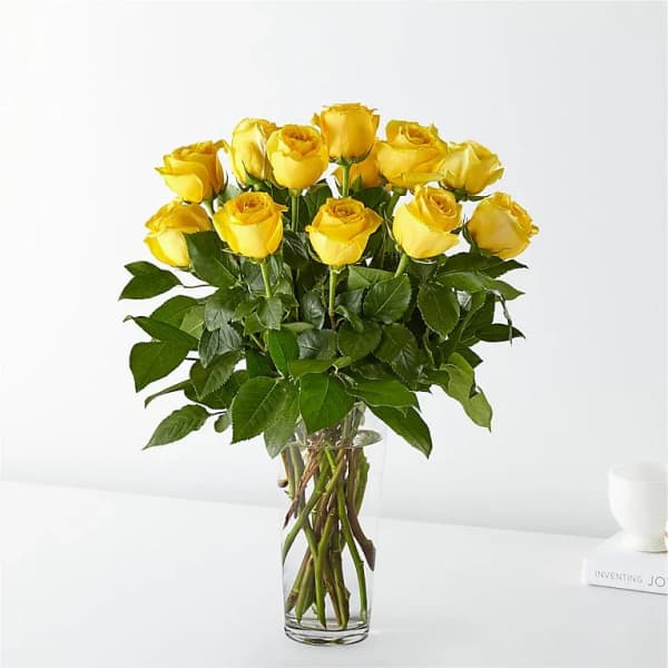 Yellow roses in a clear glass vase