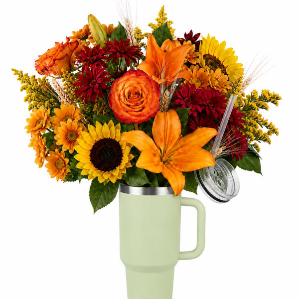 Bouquet of orange, red, and yellow flowers in a handled tumbler vase