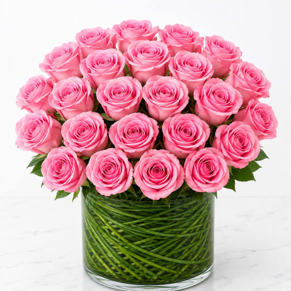 Pink roses arranged in a clear glass vase