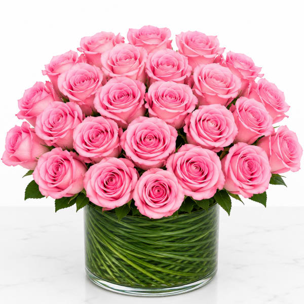 Pink roses arranged in a clear glass vase