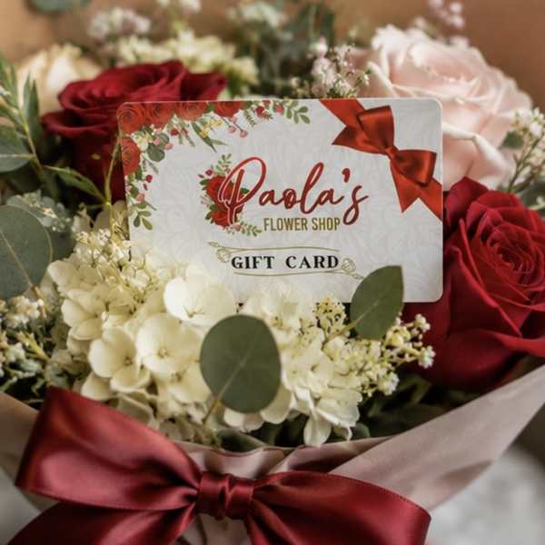 Bouquet of red and blush roses with white flowers and a gift card