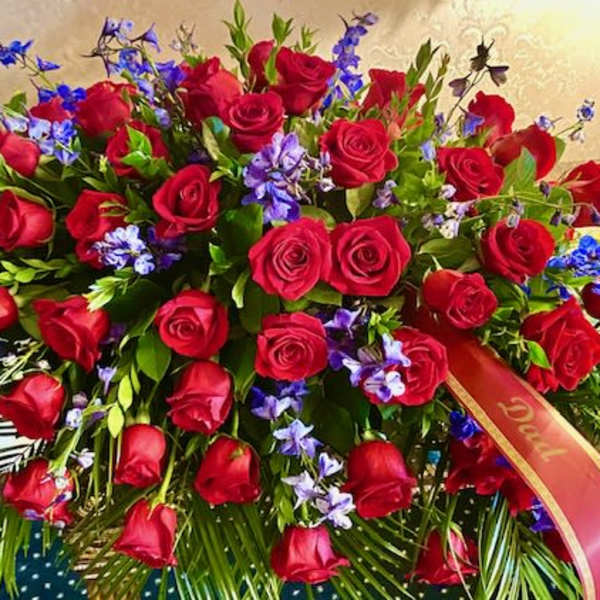 Large bouquet of red roses with blue and purple flowers