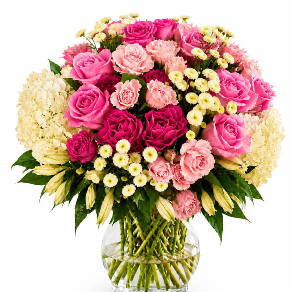 Pink and cream rose bouquet in a clear glass vase
