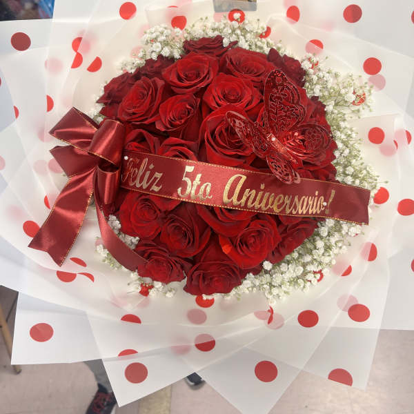 Red rose bouquet with a satin ribbon and polka-dot wrap