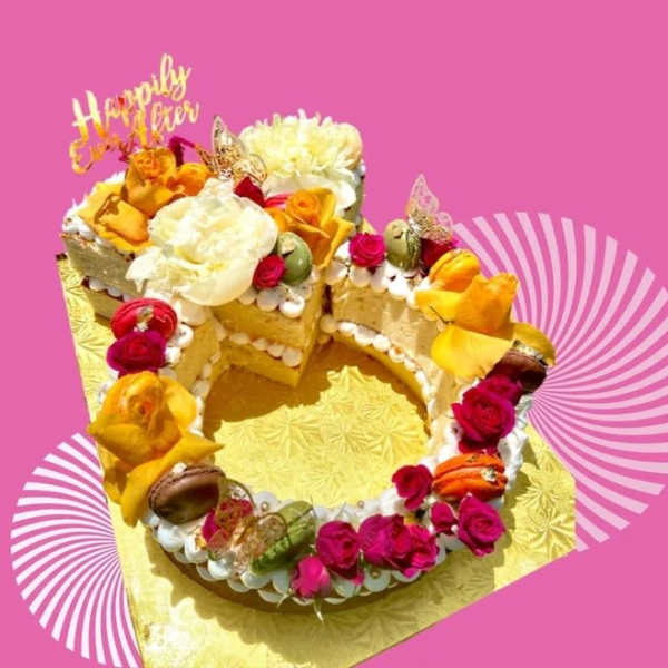 Decorated cake with flowers and a "Happily Ever After" topper