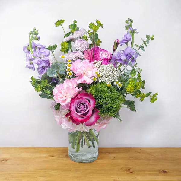 Mixed pink and purple bouquet in a clear glass vase