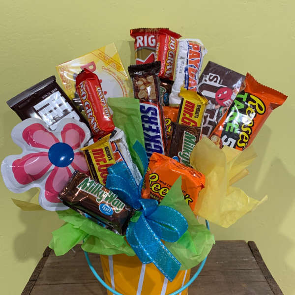 Candy bouquet in a striped bucket with a flower-shaped topper