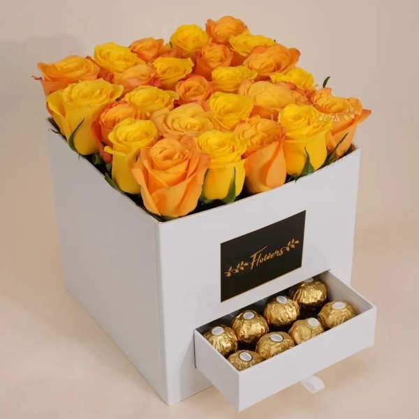 Box of yellow and orange roses with a drawer of chocolates