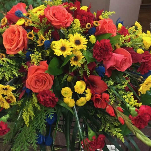 Large mixed bouquet with roses, daisies, and carnations in red, yellow, and orange