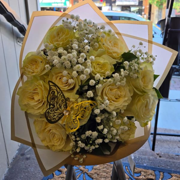 Bouquet of pale yellow roses with white baby's breath and butterfly accents
