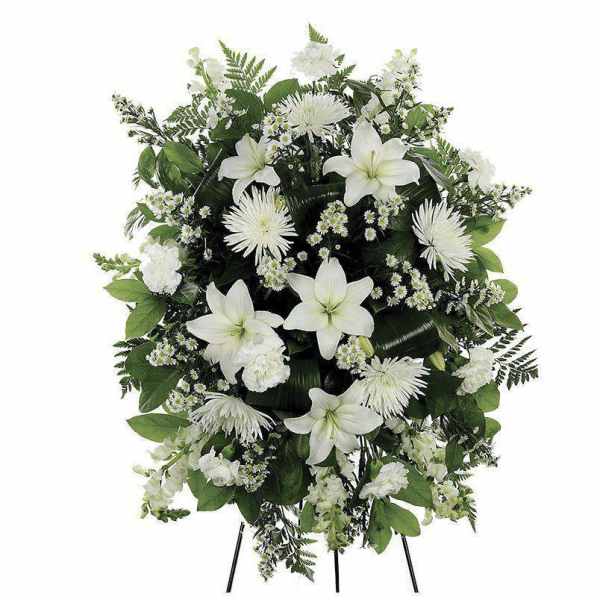 White funeral spray with lilies and chrysanthemums on a stand