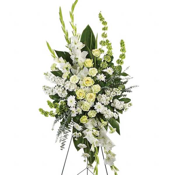 Standing white floral spray with yellow roses on an easel