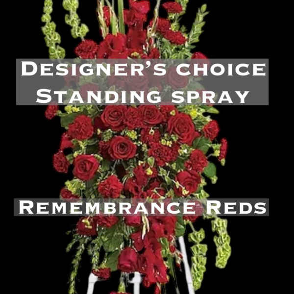 Red standing spray with roses and carnations on a white easel