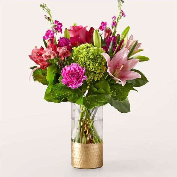 Mixed pink and green flower arrangement in a clear glass vase