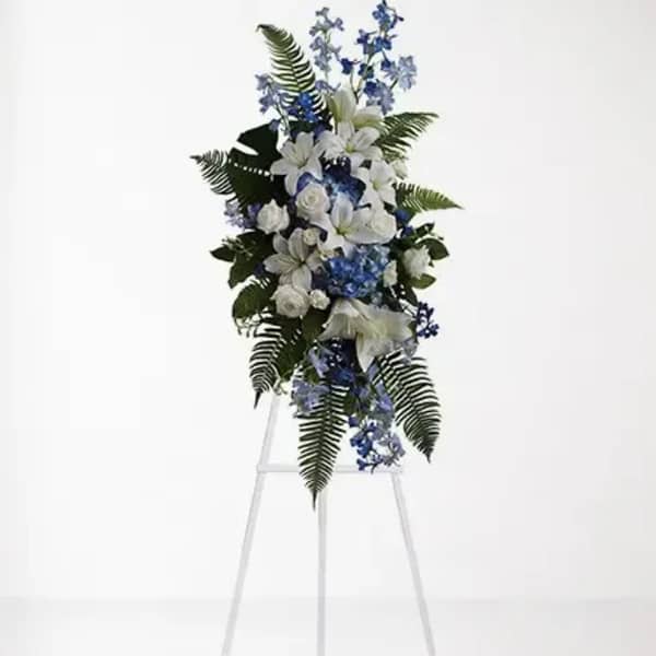 White and blue floral standing spray on a metal easel