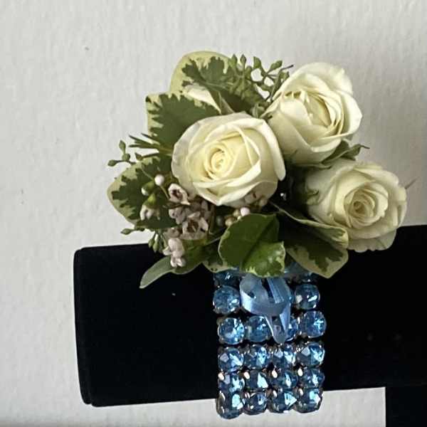 White rose corsage with blue jeweled wristband
