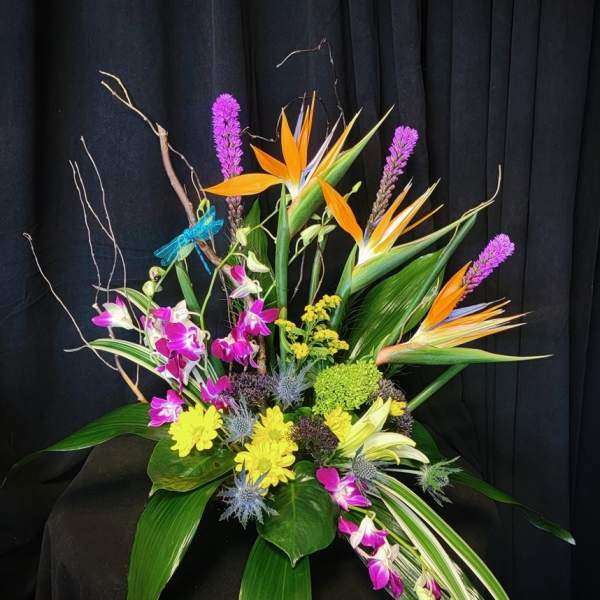 Tropical floral arrangement with orchids and bird-of-paradise flowers