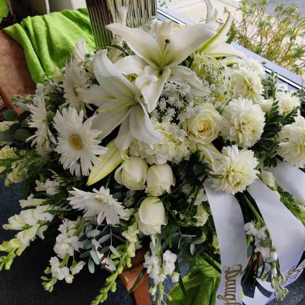 White floral spray with lilies, roses, and daisies