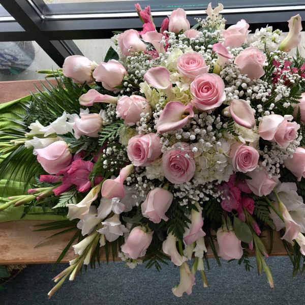 Large pink and white floral spray with roses and calla lilies