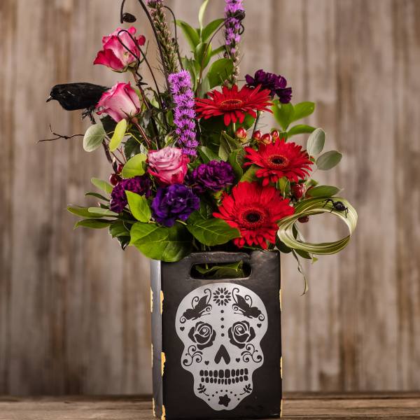 Bright mixed bouquet in a black skull-decorated box