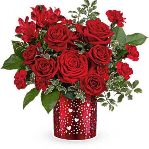 Red roses and carnations in a heart-patterned vase