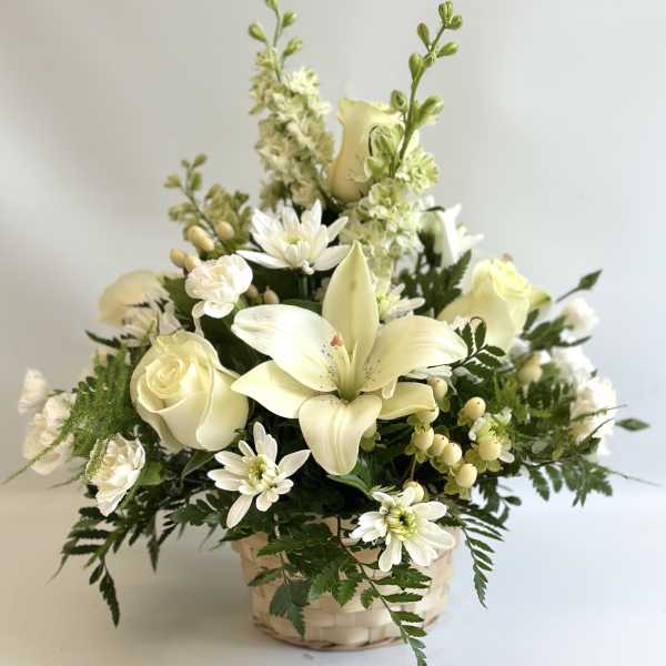 Creamy white floral arrangement in a woven basket