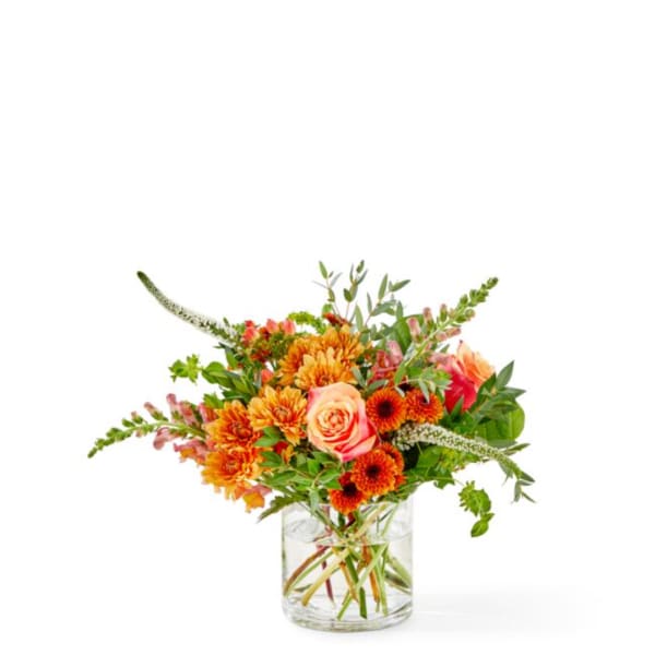 Orange and pink mixed bouquet in a clear glass vase