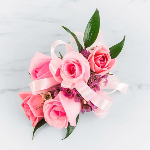 Pink rose bouquet with a pale pink ribbon and purple filler flowers