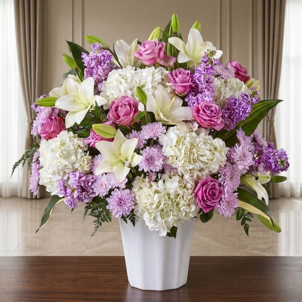 Pink and white floral arrangement in a white vase