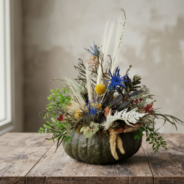 Pumpkin arrangement with dried flowers and blue accents
