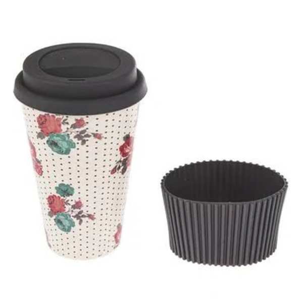 Floral-patterned takeaway coffee cup with a black lid and sleeve