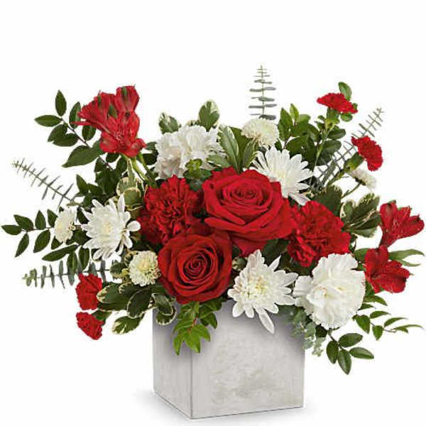 Red roses and white daisies in a square vase