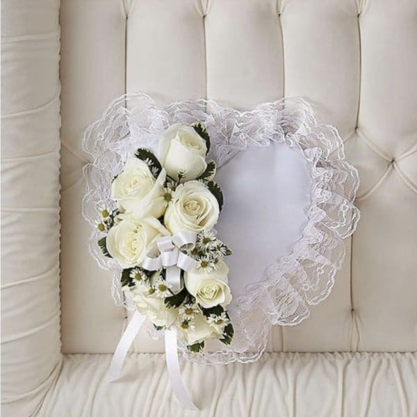 Heart-shaped lace wreath with white roses and ribbon