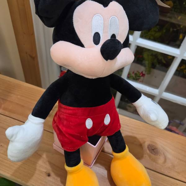 Plush Mickey Mouse toy in red shorts and yellow shoes