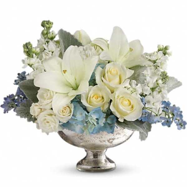 White floral arrangement in a silver pedestal bowl
