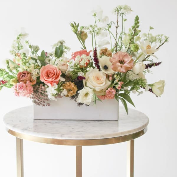 Mixed floral arrangement in a white rectangular box